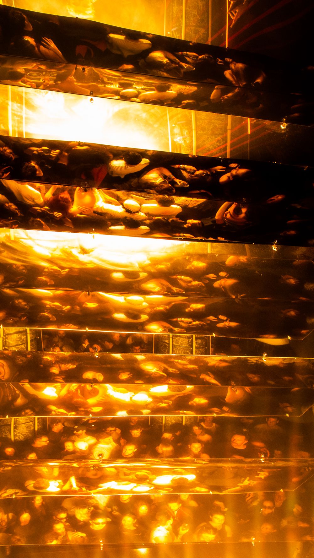 The crowd reflected in the gold mirror ceiling